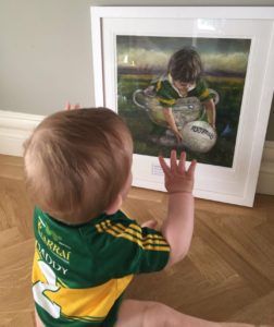 Little boy Kerry GAA jersey looking at picture  boy in Kerry jersey