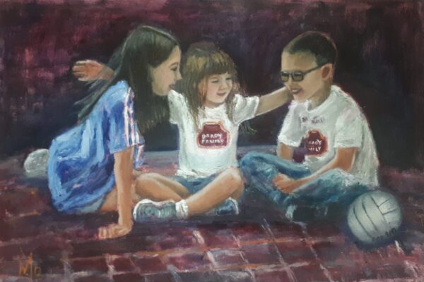 The children sitting on cross legged on a rug laughing a football