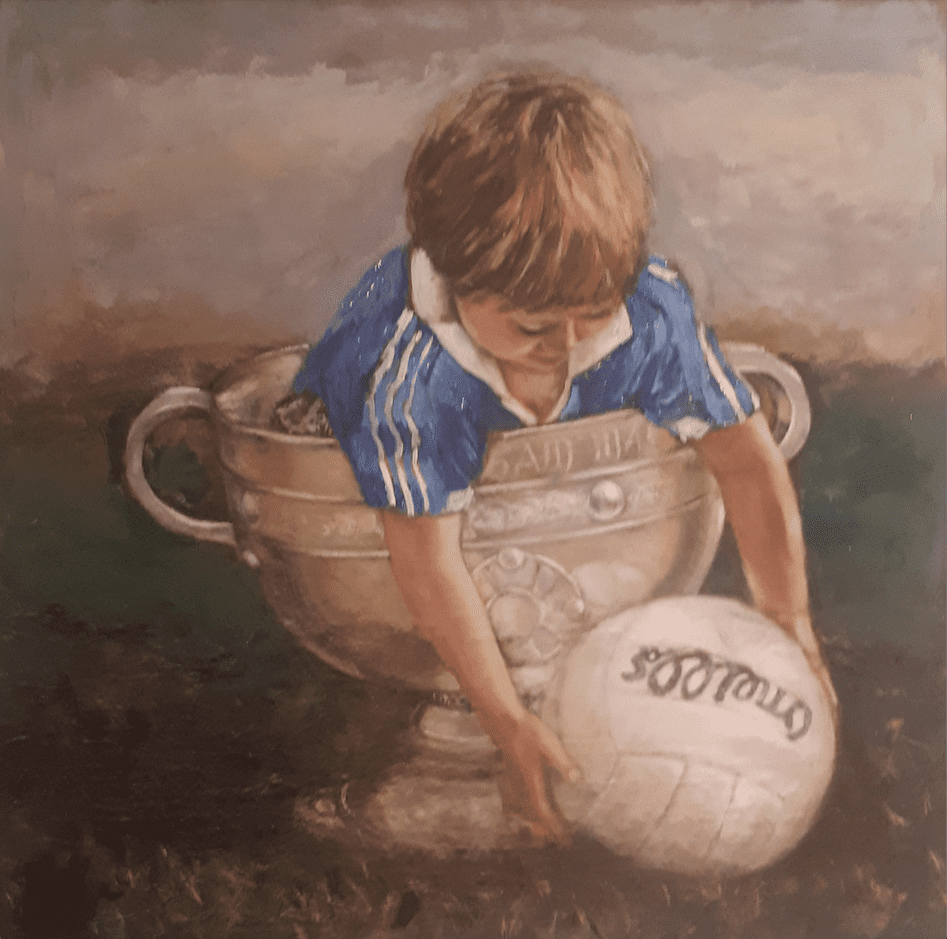 Little boy Dublin jersey the Sam Maguire reaching out to pick un a