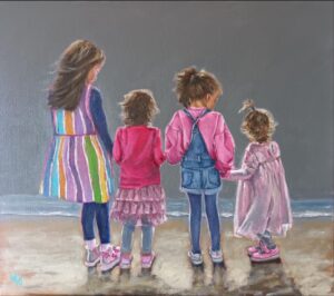 Back view four girls on the beach