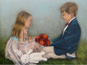 Little boy and girl dressed up for Communion Day holding a soccer ball