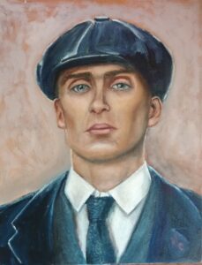 headshot of a man is a shirt and tie wearing an overcoat and a Peaky Blinder cap