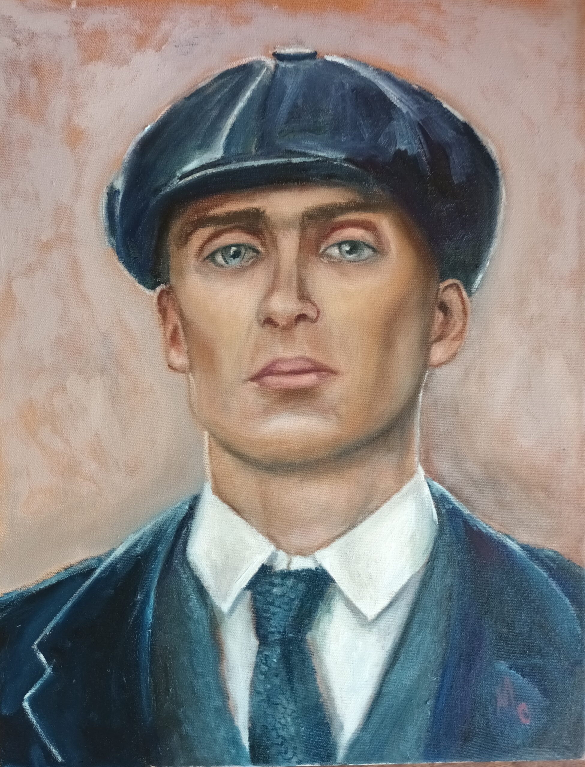 headshot of a man is a shirt and tie wearing an overcoat and a Peaky Blinder cap