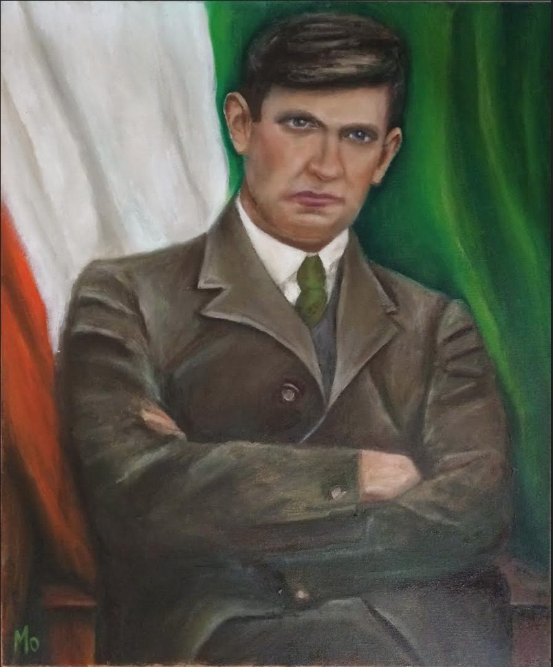 Micheal Collins sitting in front of the tricolour