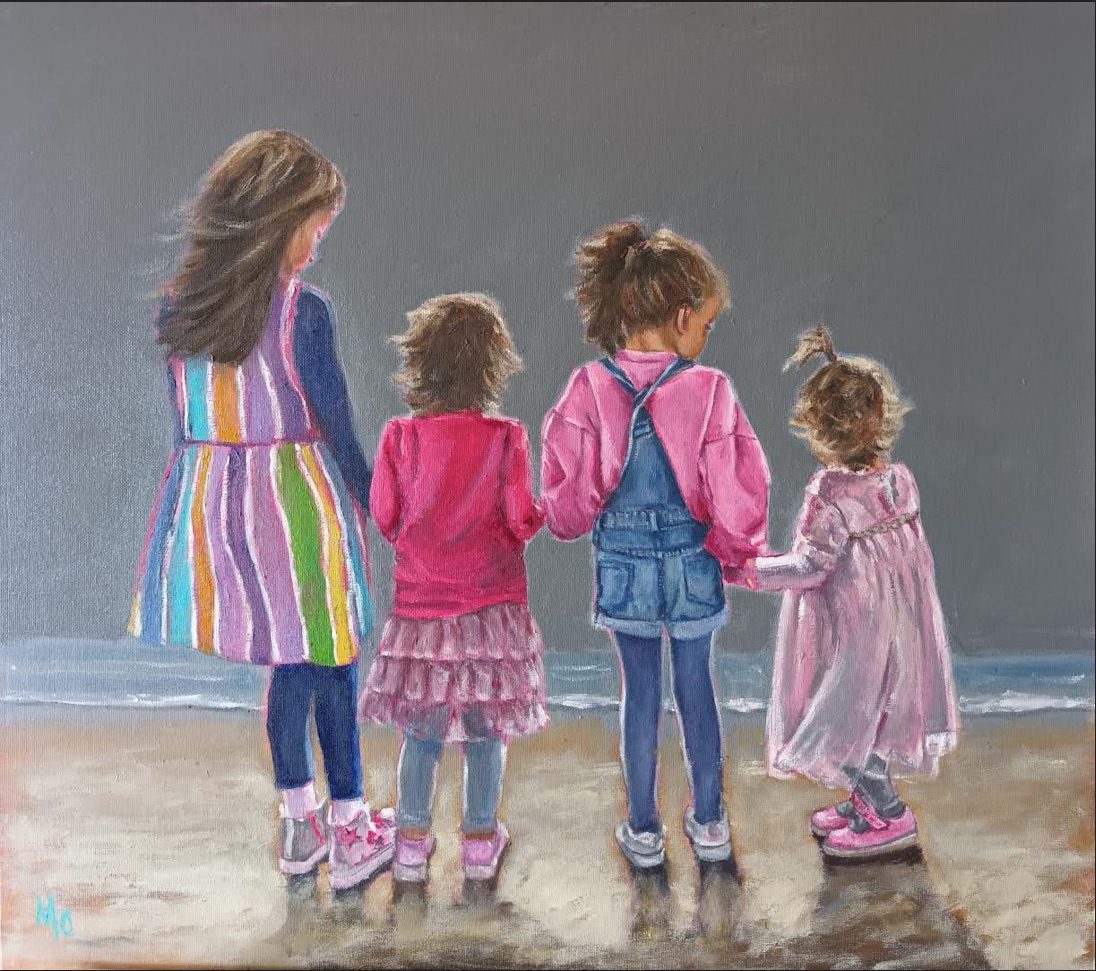 Back view of four girls at the beach